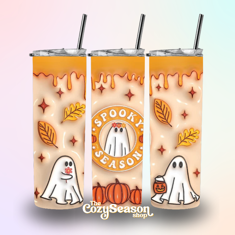 A 20oz skinny stainless steel tumbler with a printed design featuring ghosts, pumpkins, and leaves, and labeled 'Spooky Season'.