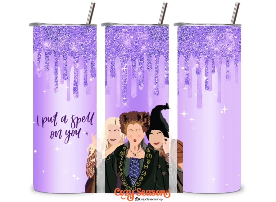 A set of three 20oz skinny tumblers with a purple color scheme, featuring a 3D effect print with the text 'I PUT A SPELL ON YOU' and an illustration of three witches. Each tumbler has a clear acrylic lid with a straw hole and is adorned with glitter.