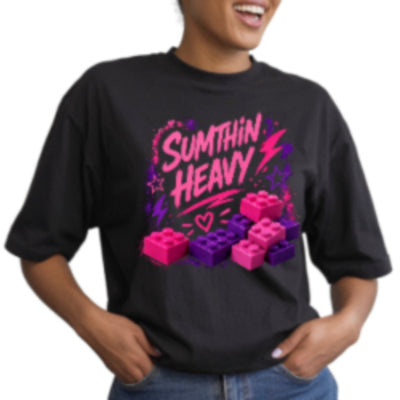 Person wearing a black t-shirt with pink and purple graphics and text.
