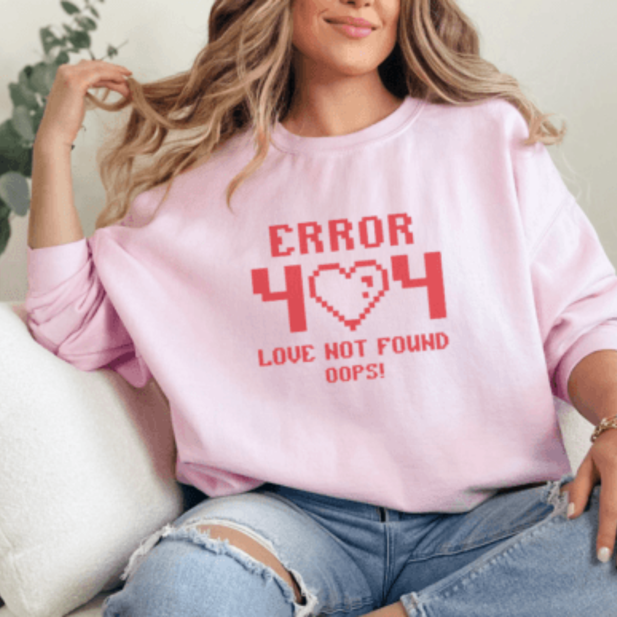 Person wearing a pink sweatshirt with 'ERROR 404 LOVE NOT FOUND OOPS!' text