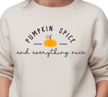 Woman wearing a beige sweatshirt with 'Pumpkin Spice and everything nice' text and pumpkin graphic.