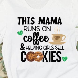 White shirt with text 'This mama runs on coffee & helping girls sell cookies' featuring a coffee cup and cookie graphic.