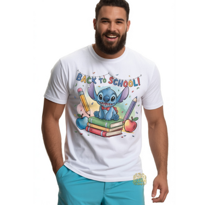 White unisex t-shirt with a vibrant "Back to School" design featuring a smiling blue alien sitting on school books flanked by giant pencils.
