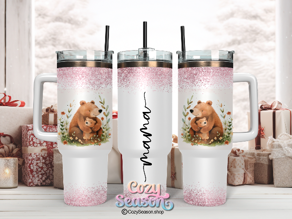 A40oz iridescent stainless steel tumbler with a pink glitter finish, featuring illustrations of a bear and a cub, and the text 'MAMA BEAR & CUB'.