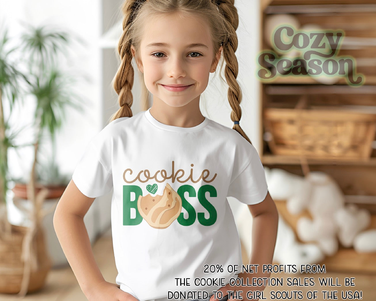 Young girl wearing a 'Cookie Boss' shirt with a cozy indoor background