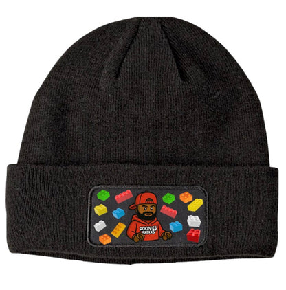 Black beanie with a colorful patch featuring a character and text on a white background