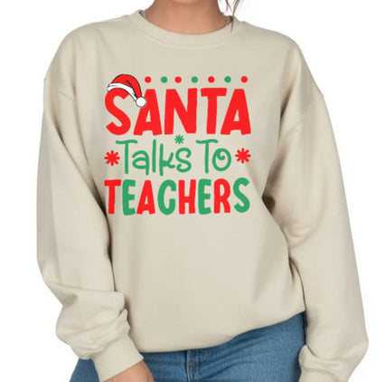 Beige sweatshirt with 'Santa Talks To Teachers' text and Santa hat graphic on a white background