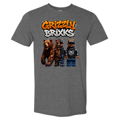 A heather gray short-sleeve t-shirt featuring a graphic print of the 'Grizzly Brixks' logo in orange and white graffiti-style lettering above three pixel-art characters resembling LEGO minifigures, one brown bear and two humans.
