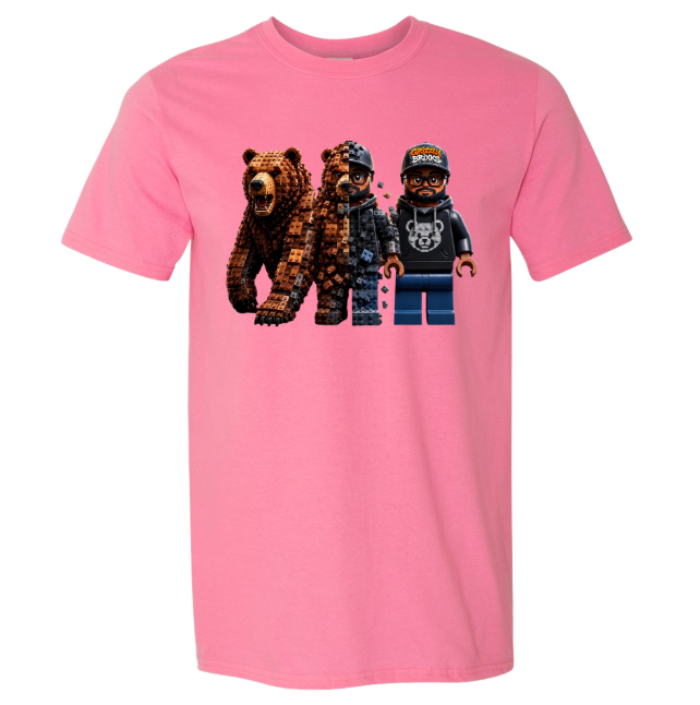 A pink short-sleeve crewneck t-shirt featuring a graphic print of two pixelated bears and a pixelated minifigure on the front, displayed against a solid white background.