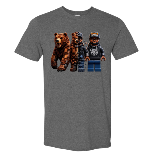 A heather gray short-sleeve crewneck t-shirt featuring a graphic print of three blocky, pixelated characters resembling Lego minifigures: a brown bear, a person in a dark jacket, and a person in a black hoodie and blue pants.