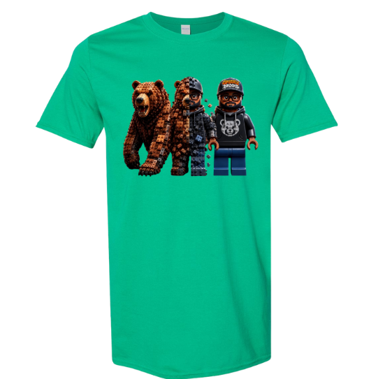 A green short-sleeve crewneck t-shirt featuring a graphic print of three blocky, pixel-art style characters: a brown bear, a dark bear in a mask, and a minifigure wearing a cap and hoodie.