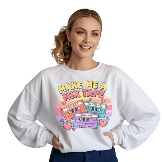 Woman wearing a white sweatshirt with a colorful 'Make Me a Mix Tape' design on a plain background