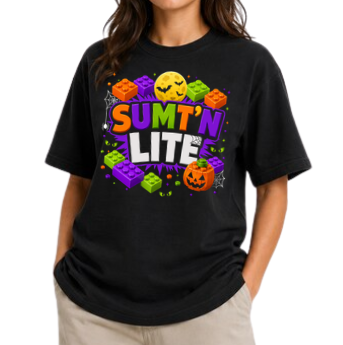 BLACK TSHIRT WITH A LEGO THEME HALLOWEEN DESIGN. THE TEXT "SUMT'N LITE" IN ORANGE, PURPLE, GREEN AND WHITE COLORS. SURROUNDED BY LEGO BRICKS OF THE SAME COLOR.  AN ORANGE JACK O LANTERN sits on the bottom right corner with spider webs in the design. a full moon with bats on the top center. 