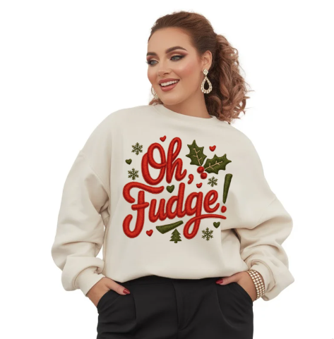 Woman wearing a cream sweatshirt with 'Oh, Fudge!' text and festive design on a white background