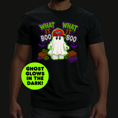 A man wearing a black t-shirt with a glowing cartoon ghost graphic and the text 'WHAT IT BOO' and 'GHOST GLOWS IN THE DARK!'.