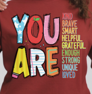T-shirt with motivational text 'YOU ARE' in colorful letters on a red background