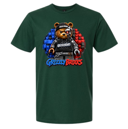 A dark green short-sleeve t-shirt featuring a graphic of a grizzly bear dressed as a toy brick minifigure, with the text 'Grizzly Brixks' below in blue and red stylized lettering.