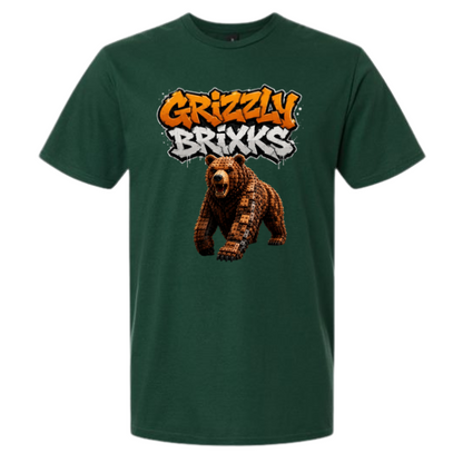 A dark green short-sleeve t-shirt with a graphic on the chest featuring the text 'Grizzly Brixks' in orange and white graffiti-style lettering above a pixelated brown grizzly bear, shown on a plain white background.