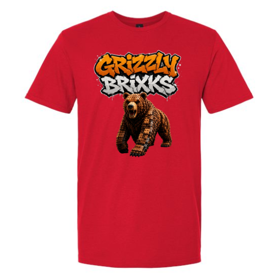 A red short-sleeve crewneck t-shirt featuring a graphic print of a brown bear under the text 'Grizzly Brixks' in orange and white graffiti-style lettering.