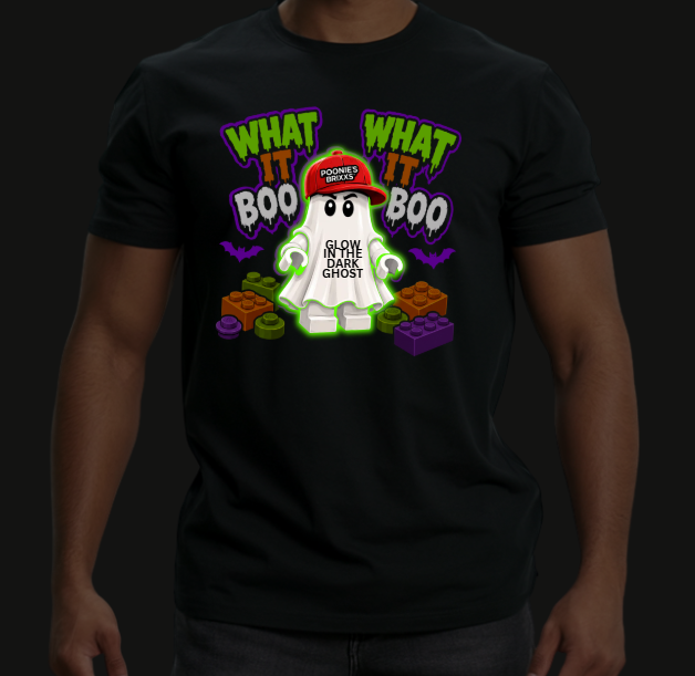 A man wearing a black t-shirt with a colorful graphic of a glowing white ghost wearing a red cap that says 'GLOW IN THE DARK GHOST'. The graphic also features the text 'WHAT IT BOO' in green and white.