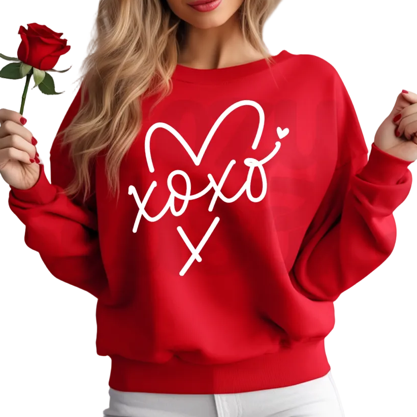 Woman wearing a red sweatshirt with 'xoxo' design, holding a red rose.